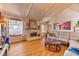 Spacious living room with vaulted ceiling, fireplace, and wood flooring at 4381 Toledo Ave, Las Vegas, NV 89121