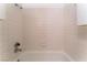 Close-up of tiled bathtub and shower featuring white ceramic tiles and chrome fixtures at 440 Elm Dr # 103, Las Vegas, NV 89169