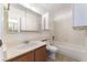 Bathroom featuring a vanity, mirror, toilet, and tiled bathtub with shower at 440 Elm Dr # 103, Las Vegas, NV 89169