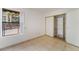Bright bedroom features tiled floors, closet with shelving, and large windows at 440 Elm Dr # 103, Las Vegas, NV 89169