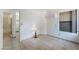 Sunlit bedroom features tiled floors, air conditioning, and an adjacent bathroom at 440 Elm Dr # 103, Las Vegas, NV 89169