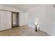 Well-lit bedroom with tiled floors, closet with shelving, and neutral wall paint at 440 Elm Dr # 103, Las Vegas, NV 89169