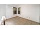 Bright bedroom with tiled floors, two windows, and a modern air conditioning unit at 440 Elm Dr # 103, Las Vegas, NV 89169