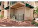 The exterior features a tan two-story condo with a patio, green awning, and well-maintained landscape at 440 Elm Dr # 103, Las Vegas, NV 89169