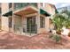 The exterior shows a tan two-story condo with a green awning, a patio and a trimmed palm tree at 440 Elm Dr # 103, Las Vegas, NV 89169