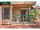 Tan two-story condo with a patio, green awning, and a meticulously maintained landscape with a palm tree at 440 Elm Dr # 103, Las Vegas, NV 89169