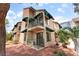 A tan two-story condo building with green awnings and private balconies, complemented by palm trees at 440 Elm Dr # 103, Las Vegas, NV 89169