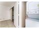 Laundry area with tiled floors, stacked washer and dryer, and closet for storage at 440 Elm Dr # 103, Las Vegas, NV 89169