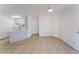 Well-lit living space with open access to the kitchen, complemented by neutral tile floors and white walls at 440 Elm Dr # 103, Las Vegas, NV 89169