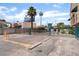 The gated parking lot is paved with parking bumpers and surrounded by buildings and signage at 440 Elm Dr # 103, Las Vegas, NV 89169