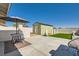 Landscaped backyard features a patio area, artificial turf, shed, and partial block wall at 445 Concord Way, Henderson, NV 89015