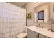 Bathroom featuring a shower-tub combo with tile surround, gray vanity, and modern fixtures at 445 Concord Way, Henderson, NV 89015