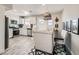 Dining area with modern light fixture, neutral colors, and an open view into the kitchen at 445 Concord Way, Henderson, NV 89015