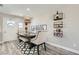 Charming dining room with modern lighting fixture and stylish furniture and décor at 445 Concord Way, Henderson, NV 89015