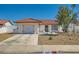 Charming single-story home featuring a tile roof, two car garage, and desert landscaping at 445 Concord Way, Henderson, NV 89015