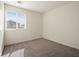 Bright bedroom featuring a large window and neutral carpet at 4675 Color Up Ct # 101, Las Vegas, NV 89122