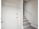 A clean entryway with a white door and neutral color palette, stairs leading up to the living area at 4675 Color Up Ct # 101, Las Vegas, NV 89122