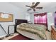 Cozy bedroom with a ceiling fan, comfortable bed, and a large window for natural light at 4858 Longshot Dr, Las Vegas, NV 89122