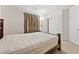 Bedroom featuring a dark wood frame bed, bedside table, and double-door closet at 4858 Longshot Dr, Las Vegas, NV 89122