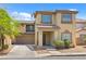 Two-story home featuring a well-maintained front yard and attached two-car garage at 4858 Longshot Dr, Las Vegas, NV 89122