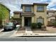 Two-story home with tan stucco exterior, tile roof, covered porch, and landscaped front yard at 4858 Longshot Dr, Las Vegas, NV 89122