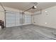Spacious garage with a white garage door and concrete flooring at 4858 Longshot Dr, Las Vegas, NV 89122