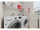 Laundry room with modern LG washer and dryer units, and shelving for storage at 4858 Longshot Dr, Las Vegas, NV 89122
