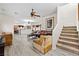 Open-concept living room with luxury vinyl plank flooring, ceiling fan and stairwell access to the second floor at 4858 Longshot Dr, Las Vegas, NV 89122