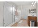 Well-lit main bathroom with a tiled floor, standing shower, and separate bathtub at 4858 Longshot Dr, Las Vegas, NV 89122