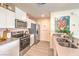 Close-up of the kitchen area showing stainless-steel appliances, sleek countertops, and ample storage at 4988 Fern Mesa Ave # Lot 135, Las Vegas, NV 89139