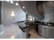 Unique home bar featuring granite countertops, modern cabinetry, and statement lighting at 5210 Villa Dante Ave, Las Vegas, NV 89141