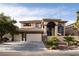 A large two-story home displays a three-car garage, desert landscaping, and a barrel tile roof at 5210 Villa Dante Ave, Las Vegas, NV 89141