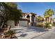 Stately home with a three-car garage, well-manicured landscaping, and a secure gated entryway at 5210 Villa Dante Ave, Las Vegas, NV 89141