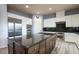 Gourmet kitchen featuring a large granite island, stainless steel appliances, and ample cabinet space at 5210 Villa Dante Ave, Las Vegas, NV 89141