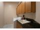 Functional laundry room with ample storage, utility sink, modern washer, and space saving countertops at 5210 Villa Dante Ave, Las Vegas, NV 89141