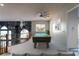 Stylish loft space with a pool table and chandelier overlooking the living area below at 5210 Villa Dante Ave, Las Vegas, NV 89141