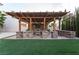 This outdoor patio features a pergola, bar, and outdoor seating at 5210 Villa Dante Ave, Las Vegas, NV 89141