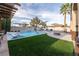 This backyard has a crystal blue pool, a fire pit and a lounge area perfect for entertaining at 5210 Villa Dante Ave, Las Vegas, NV 89141