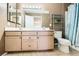 Bathroom featuring double sink vanity, shower/tub combo with curtain, and natural lighting at 5241 Caspian Springs Dr # 203, Las Vegas, NV 89120