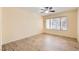 Bedroom with laminate wood flooring, ceiling fan, and bright window at 5241 Caspian Springs Dr # 203, Las Vegas, NV 89120