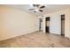 A well-lit bedroom featuring wood floors, a ceiling fan, and closet with sliding doors at 5241 Caspian Springs Dr # 203, Las Vegas, NV 89120