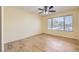 Bright bedroom featuring a large window and laminate wood flooring at 5241 Caspian Springs Dr # 203, Las Vegas, NV 89120