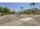 Well-maintained community entrance with lush landscaping, mature trees, and clear signage at 5241 Caspian Springs Dr # 203, Las Vegas, NV 89120