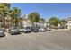 Exterior shot of complex with ample parking, and lush landscaping with mature trees at 5241 Caspian Springs Dr # 203, Las Vegas, NV 89120