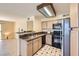 Cozy kitchen with granite counters, stainless steel refrigerator, and black appliances at 5241 Caspian Springs Dr # 203, Las Vegas, NV 89120