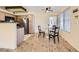 Cozy kitchen with stainless steel appliances, dining table set, and laminate flooring at 5241 Caspian Springs Dr # 203, Las Vegas, NV 89120