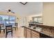 Kitchen view into dining area with granite counters and stainless steel sink at 5241 Caspian Springs Dr # 203, Las Vegas, NV 89120