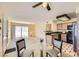 Open-concept living and dining area features a ceiling fan, sliding door, and bright natural light at 5241 Caspian Springs Dr # 203, Las Vegas, NV 89120