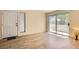 Bright living room with hardwood floors and sliding glass door. Neutral paint and modern finishes at 5241 Caspian Springs Dr # 203, Las Vegas, NV 89120
