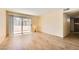 Spacious living area featuring laminate wood flooring and abundant natural light from sliding glass doors at 5241 Caspian Springs Dr # 203, Las Vegas, NV 89120